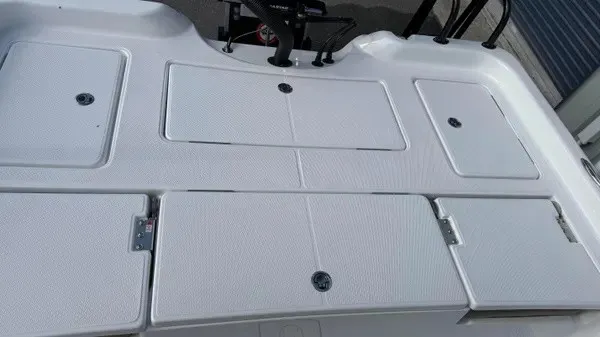 Slide: The Image of The image shows the deck of a Blazer PureBay 2400 boat with multiple storage compartments. - 12