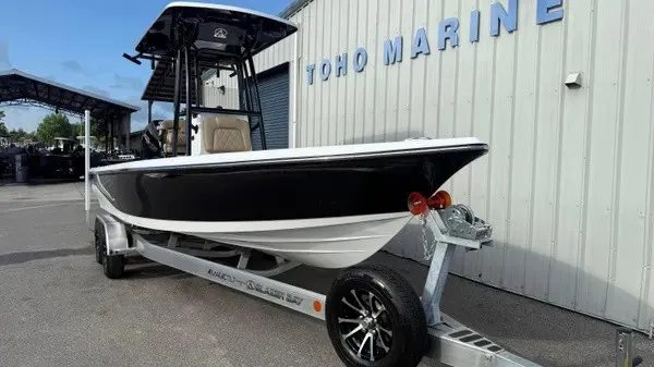 Slide: The Image of A black and white boat on a trailer in front of a building labeled "TOHO MARINE." - 9