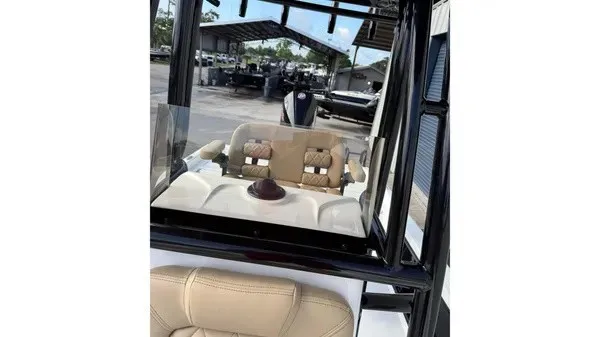 Slide: The Image of The image shows the cockpit of a Blazer PureBay 2400 boat with beige seats and a steering wheel. - 21