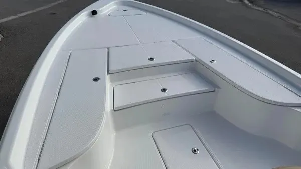Slide: The Image of The image shows the deck of a 2026 Blazer PureBay 2400 boat with storage hatches. - 16