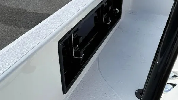 Slide: The Image of Close-up of a boat deck with a black storage compartment and white surfaces. - 19