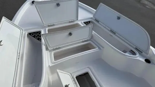 Slide: The Image of The image shows the deck of a Blazer PureBay 2400 boat with multiple open storage compartments. - 17