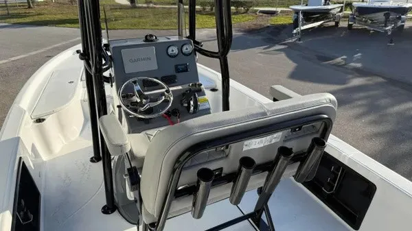 Slide: The Image of The image shows the cockpit of a Blazer PureBay 2200 boat with a helm console and rod holders. - 30