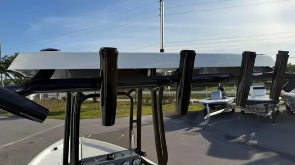 Slide: The Image of A boat with multiple fishing rod holders on the roof, with more boats visible in the background. - 28