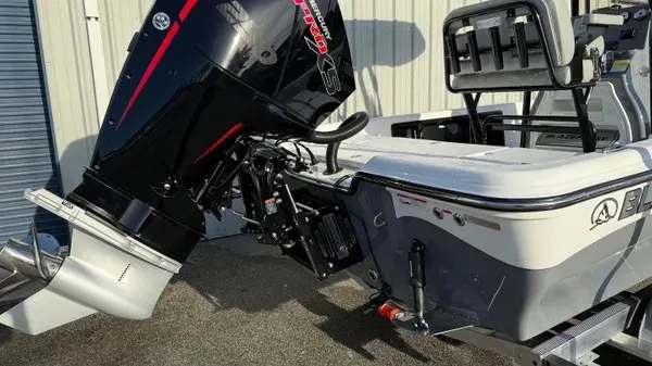 Slide: The Image of A Blazer PureBay 2200 boat with a powerful outboard motor, docked at a marina. - 7