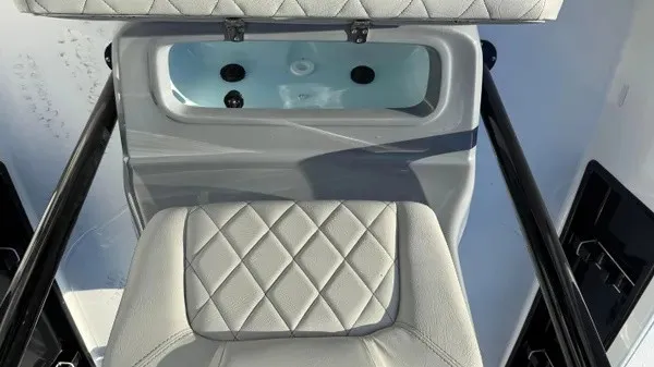 Slide: The Image of A sleek seat with quilted pattern and a built-in basin on a boat. - 15