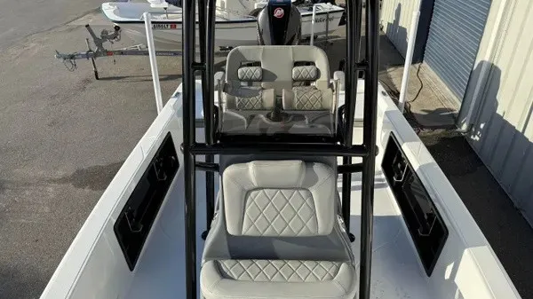Slide: The Image of The image shows the cockpit of a Blazer PureBay 2200 boat with gray seats and black frame. - 12