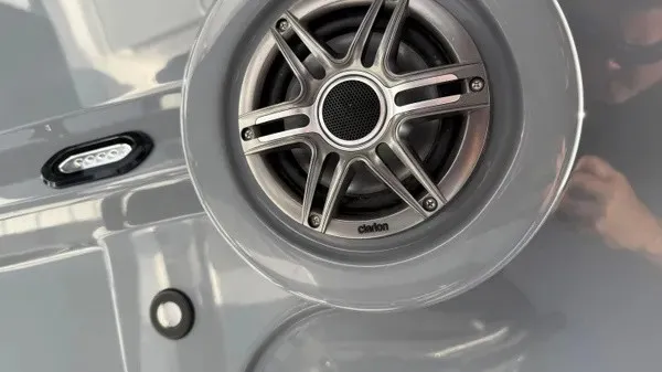 Slide: The Image of Close-up of a speaker on a boat, surrounded by glossy material. - 22