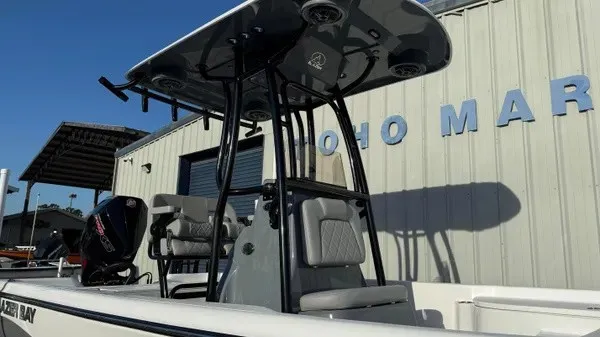 Slide: The Image of The image shows a Blazer PureBay 2200 boat with a modern T-top and cushioned seats. - 5