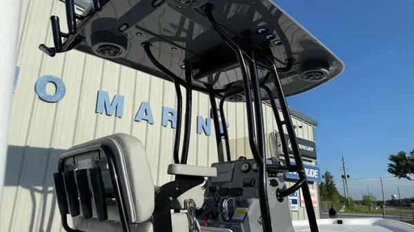 Slide: The Image of The image shows the helm of a Blazer PureBay 2200 boat with a black T-top. - 6