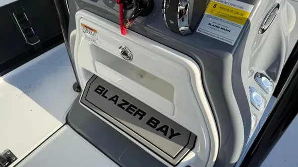 Slide: The Image of The image shows the helm of a Blazer PureBay 2200 boat with a Blazer Bay logo. - 24