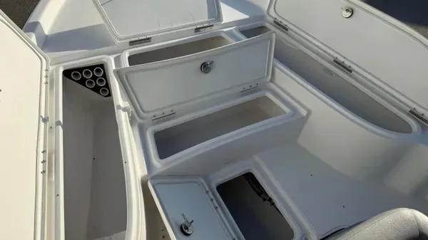 Slide: The Image of The image shows the storage area of a Blazer PureBay 2200 boat with multiple compartments. - 13