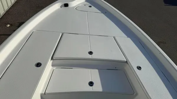 Slide: The Image of The image shows the deck of a Blazer PureBay 2200 boat with multiple storage compartments. - 11