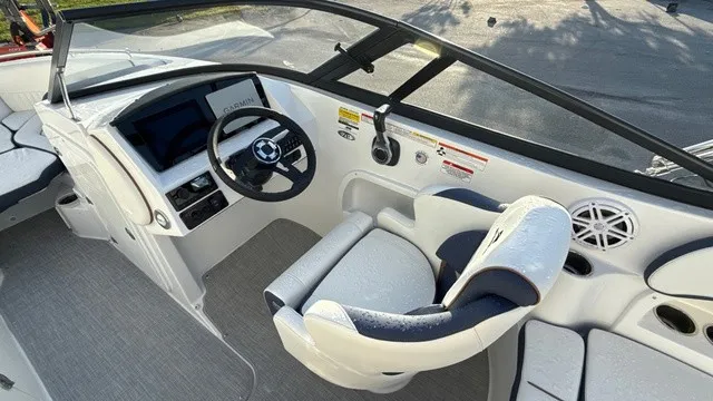 Slide: The Image of The image shows the cockpit of a 2027 Stingray 211 DC boat with a modern helm. - 10