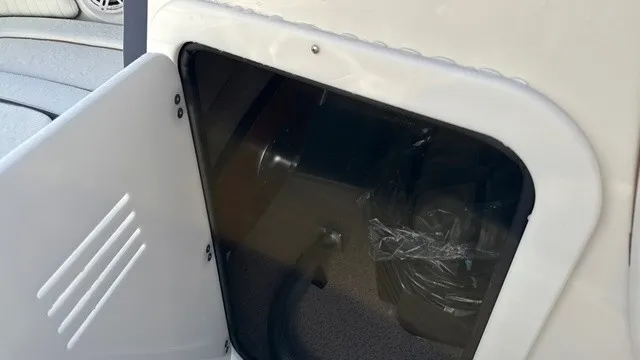 Slide: The Image of A storage compartment with a partially open door reveals the interior of a boat. - 12
