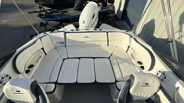 Slide: The Image of The image shows the cockpit of a Stingray 211 DC boat with white upholstery. - 9