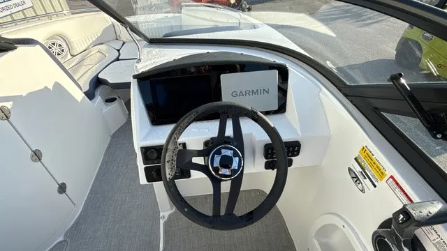 Slide: The Image of The image shows the cockpit of a Stingray 211 DC boat with a Garmin navigation system. - 19