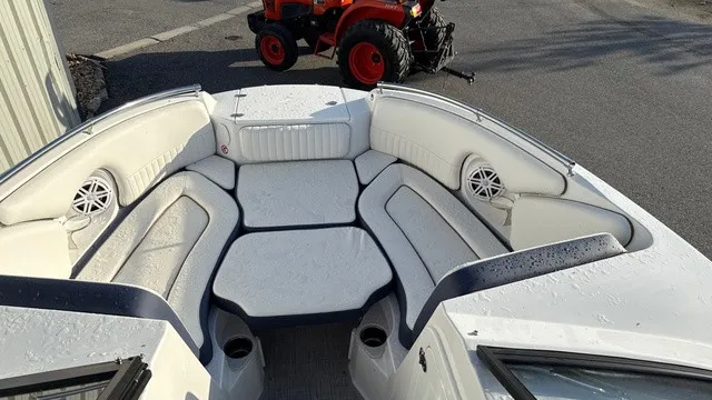 Slide: The Image of The image shows the cockpit of a 2027 Stingray 211 DC boat with white upholstery. - 8