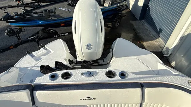 Slide: The Image of The image shows the stern of a Stingray 211 DC boat with a Suzuki outboard motor. - 16