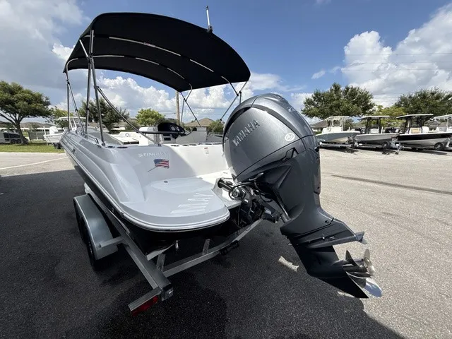 Slide: The Image of The image shows a 2027 Stingray 212 SC boat on a trailer. It features a black sunshade and a Yamaha outboard motor. - 4