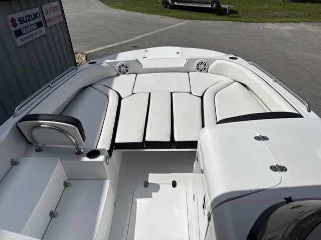 Slide: The Image of The image shows the cockpit of a 2027 Stingray 212 SC boat with white upholstery. - 8