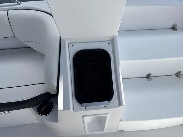 Slide: The Image of The image shows a white boat seat with an integrated storage compartment. - 17