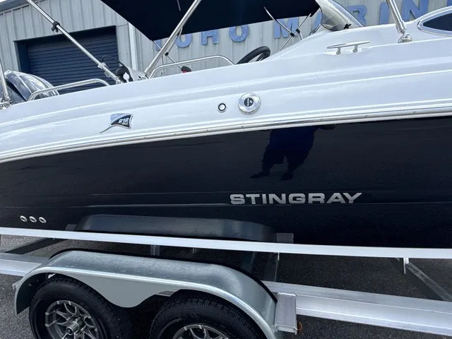 Slide: The Image of A 2027 Stingray 212 SC boat on a trailer, featuring a sleek black hull. - 2
