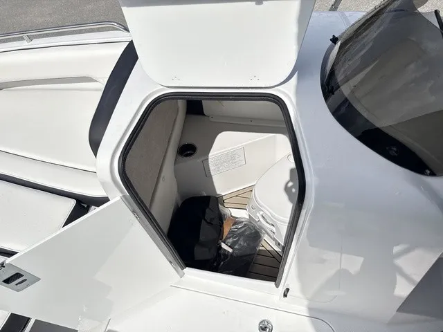 Slide: The Image of The image shows the interior of a 2027 Stingray 212 SC boat with a small cabin. - 9