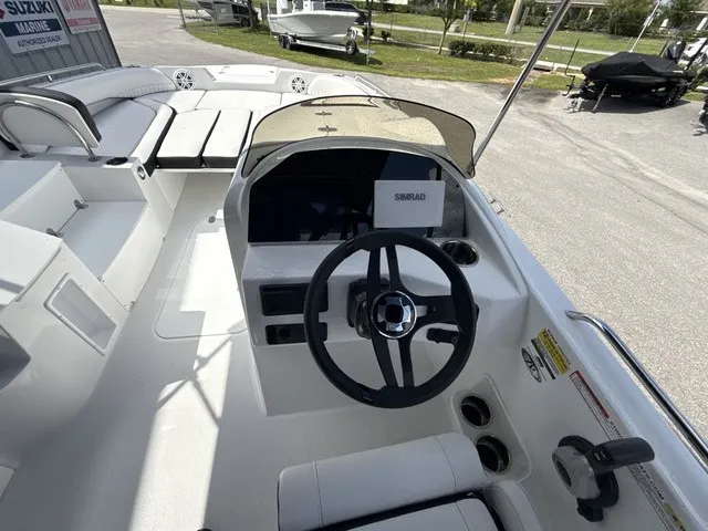 Slide: The Image of The image shows the cockpit of a 2027 Stingray 212 SC boat with a modern helm. - 13