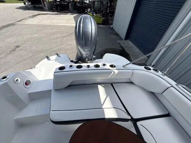 Slide: The Image of The image shows the stern of a Stingray 212 SC boat with an outboard motor and white upholstery. - 14