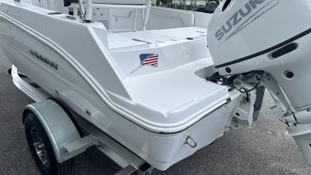 Slide: The Image of A white Stingray 173 CC boat from 2027 with a Suzuki outboard motor on a trailer. - 6