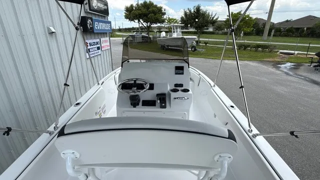 Slide: The Image of The image shows the cockpit of a 2027 Stingray 173 CC boat with a helm console and Bimini top. - 8