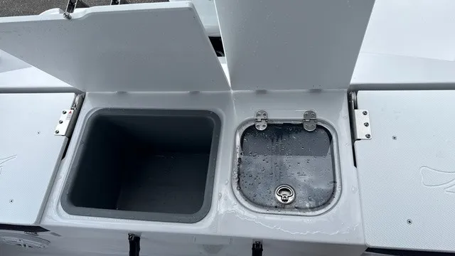 Slide: The Image of The image shows two open storage compartments on a boat, one with a drain. - 17