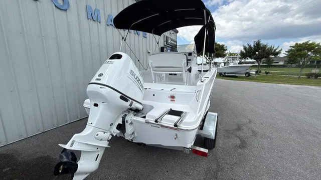Slide: The Image of A white 2027 Stingray 173 CC boat with a black sunshade, parked on a trailer. - 4