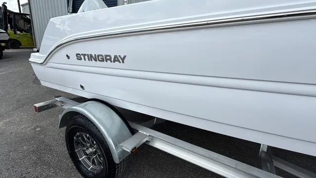 Slide: The Image of A white Stingray boat, model 173 CC, parked on a trailer. - 3