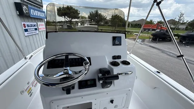 Slide: The Image of The image shows the helm of a 2027 Stingray 173 CC boat with steering wheel and instruments. - 15