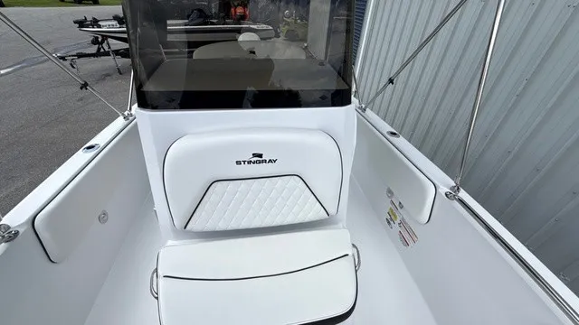 Slide: The Image of The image shows the cockpit of a 2027 Stingray 173 CC boat with white upholstery. - 11