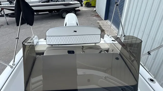 Slide: The Image of The image shows the cockpit of a 2027 Stingray 173 CC boat with tinted windshields. - 13