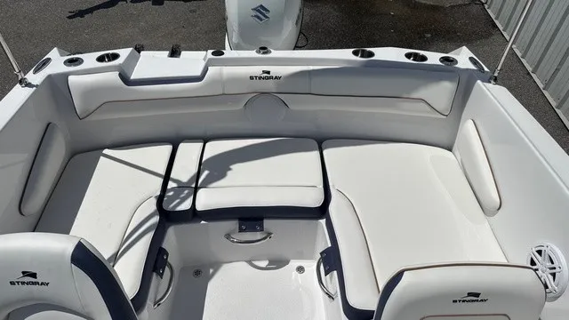 Slide: The Image of The image shows the cockpit of a Stingray 172 DC boat with white upholstery and cup holders. - 14