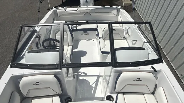 Slide: The Image of The image shows the cockpit of a 2027 Stingray 172 DC boat with white seats and black framing. - 12