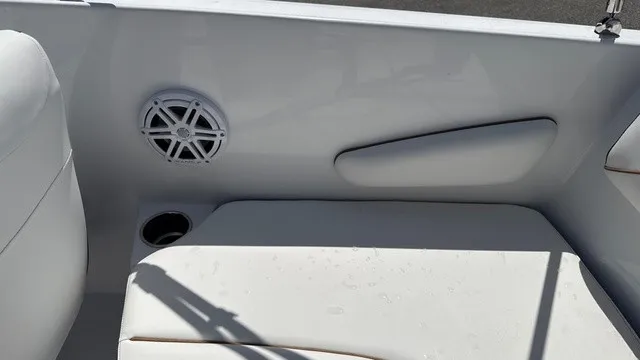 Slide: The Image of The image shows a white seating area of a boat with a speaker and a cup holder. - 15