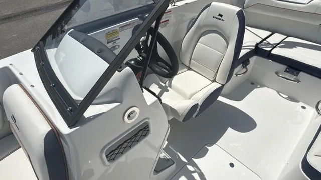 Slide: The Image of The image shows the cockpit of a Stingray 172 DC boat with a white seat and steering wheel. - 13