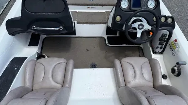 Slide: The Image of The image shows the cockpit of a 2006 Stratos 294 Pro XL boat with two seats and a helm. - 10