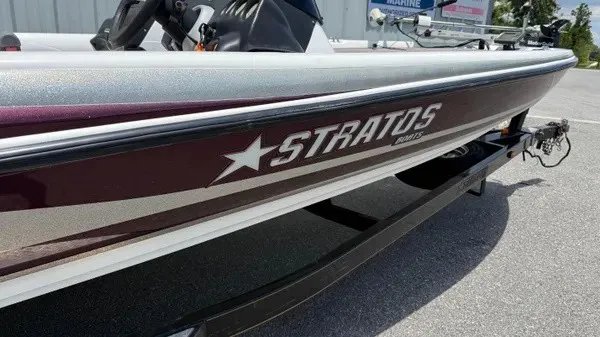 Slide: The Image of A 2006 Stratos 294 Pro XL boat with a sleek hull and prominent logo. - 3
