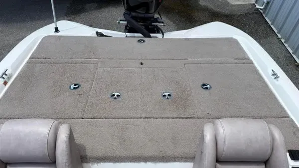 Slide: The Image of The image shows the deck of a 2006 Stratos 294 Pro XL boat with cushioned seats. - 12