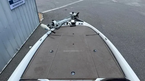 Slide: The Image of The image shows the bow deck of a 2006 Stratos 294 Pro XL boat with gray carpeting. - 9
