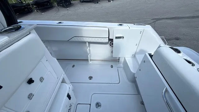 Slide: The Image of The image shows the cockpit of a 2027 Stingray 253 CC boat with white seating and storage. - 19