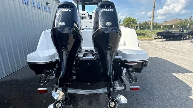 Slide: The Image of The image shows the rear of a Stingray 253 CC boat with two outboard engines. - 3