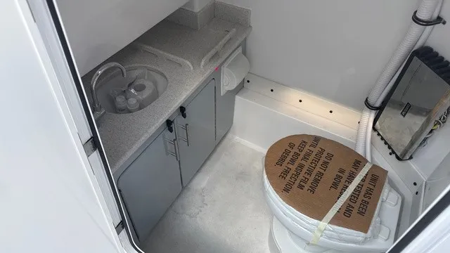 Slide: The Image of The image shows a boat bathroom with a toilet and a sink. - 12