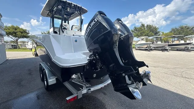 Slide: The Image of A modern 2027 Stingray 253 CC with dual outboard engines on a trailer. - 4
